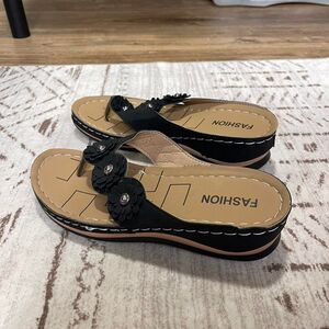 Black platform sandals with floral embellishments. Size 39/8.5